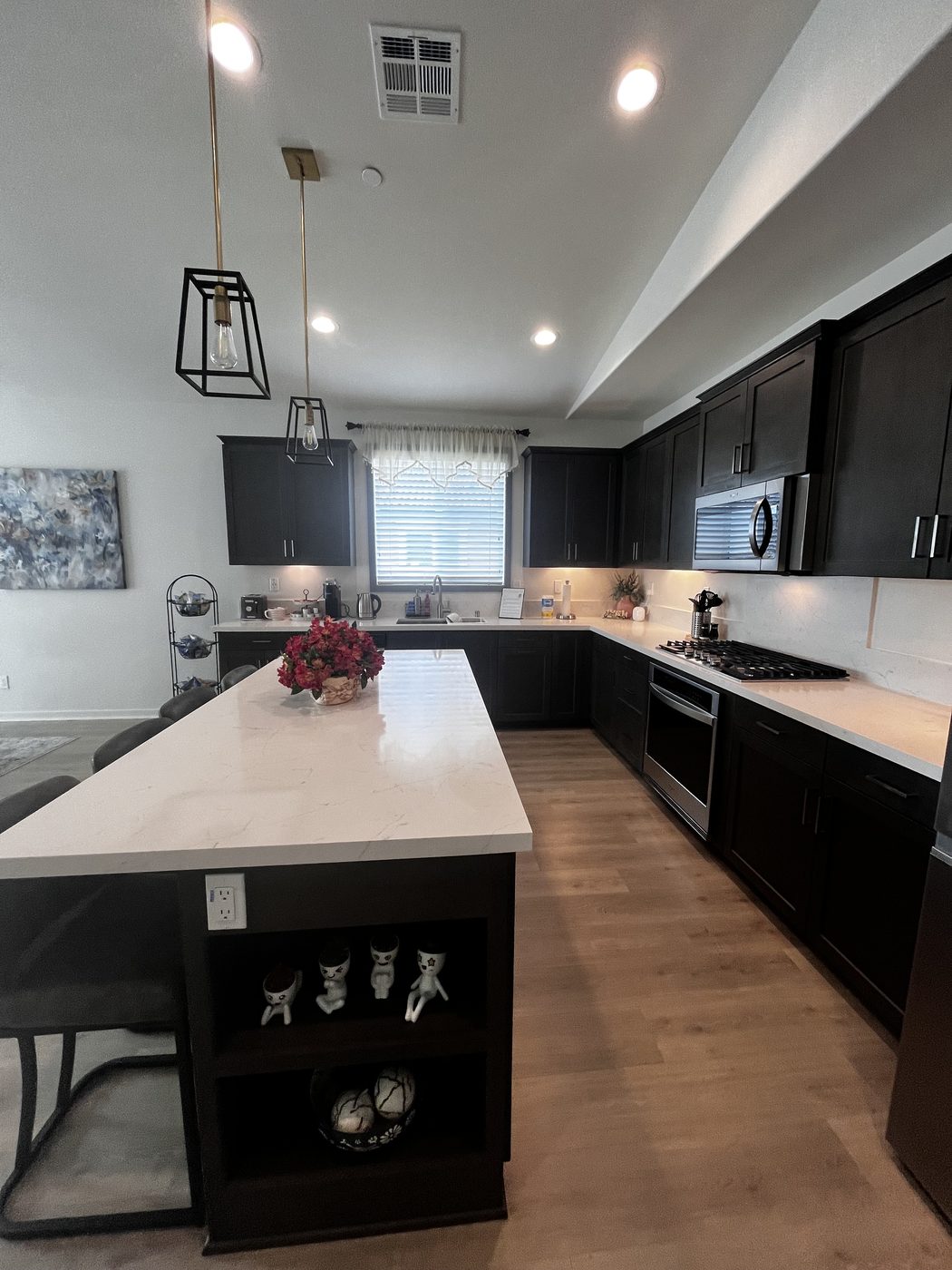 Kitchen with dark cabinets and white quartz counters after a deep clean