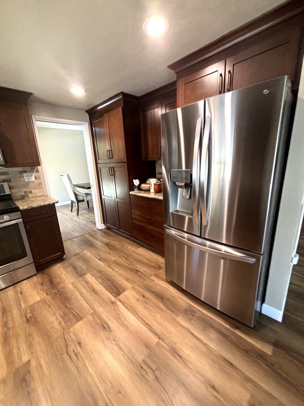 Kitchen with wood cabinets and stainless refrigerator after cleaning