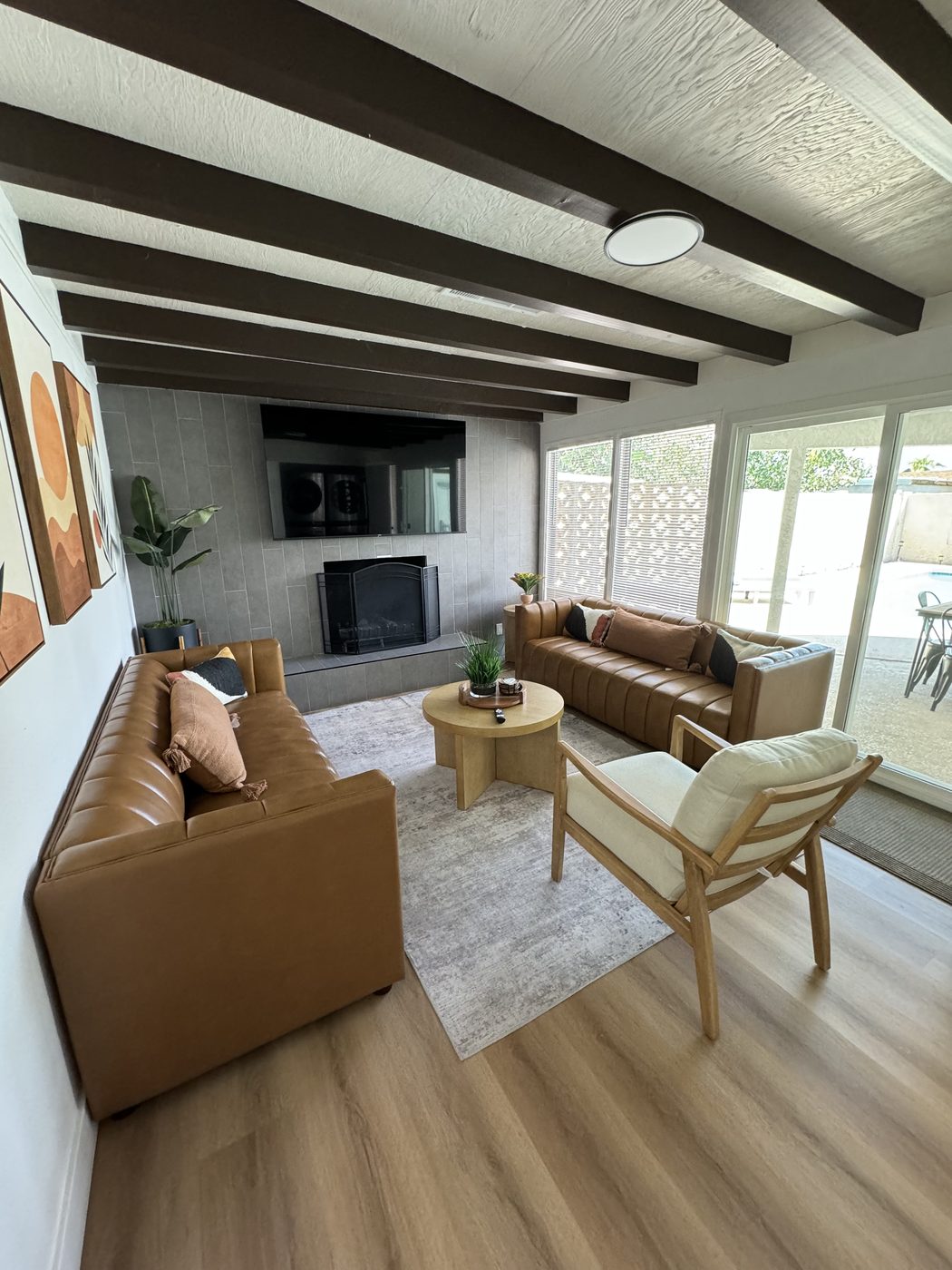 Living room with leather sofas and hardwood floors after a full clean