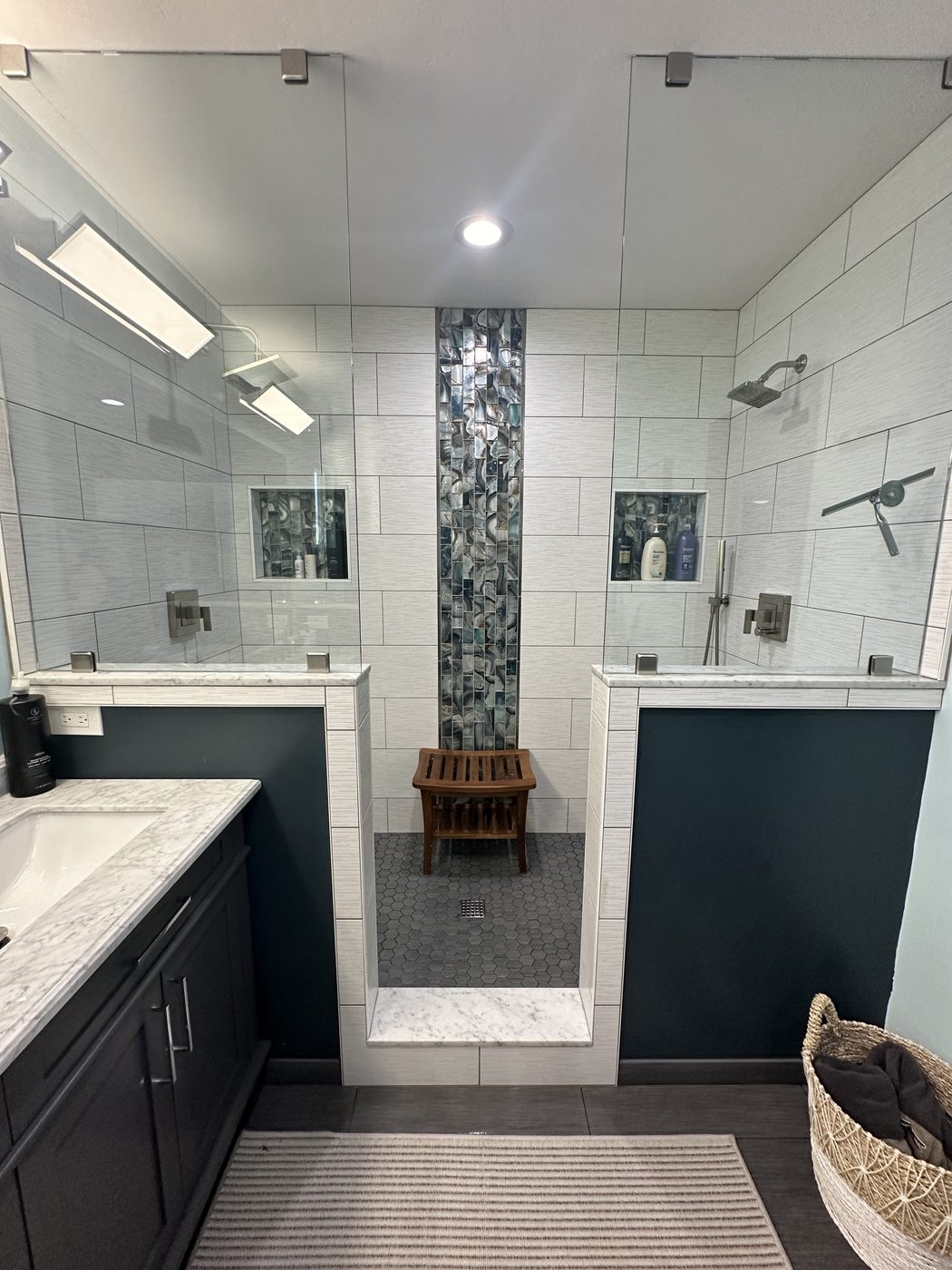 Primary bathroom with tiled walk-in shower and double vanity after cleaning