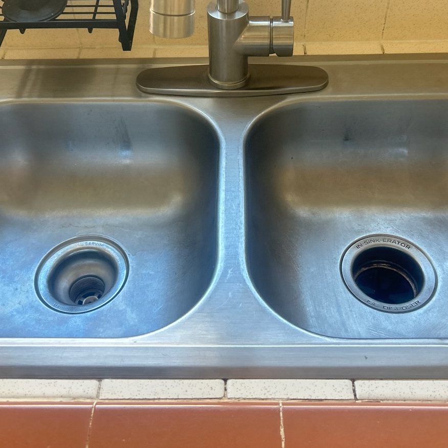 Kitchen sink before and after a move-out clean — after
