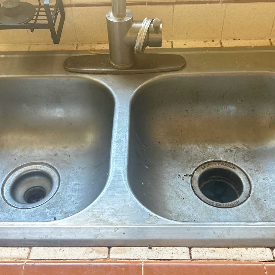 Kitchen sink before and after a move-out clean — before