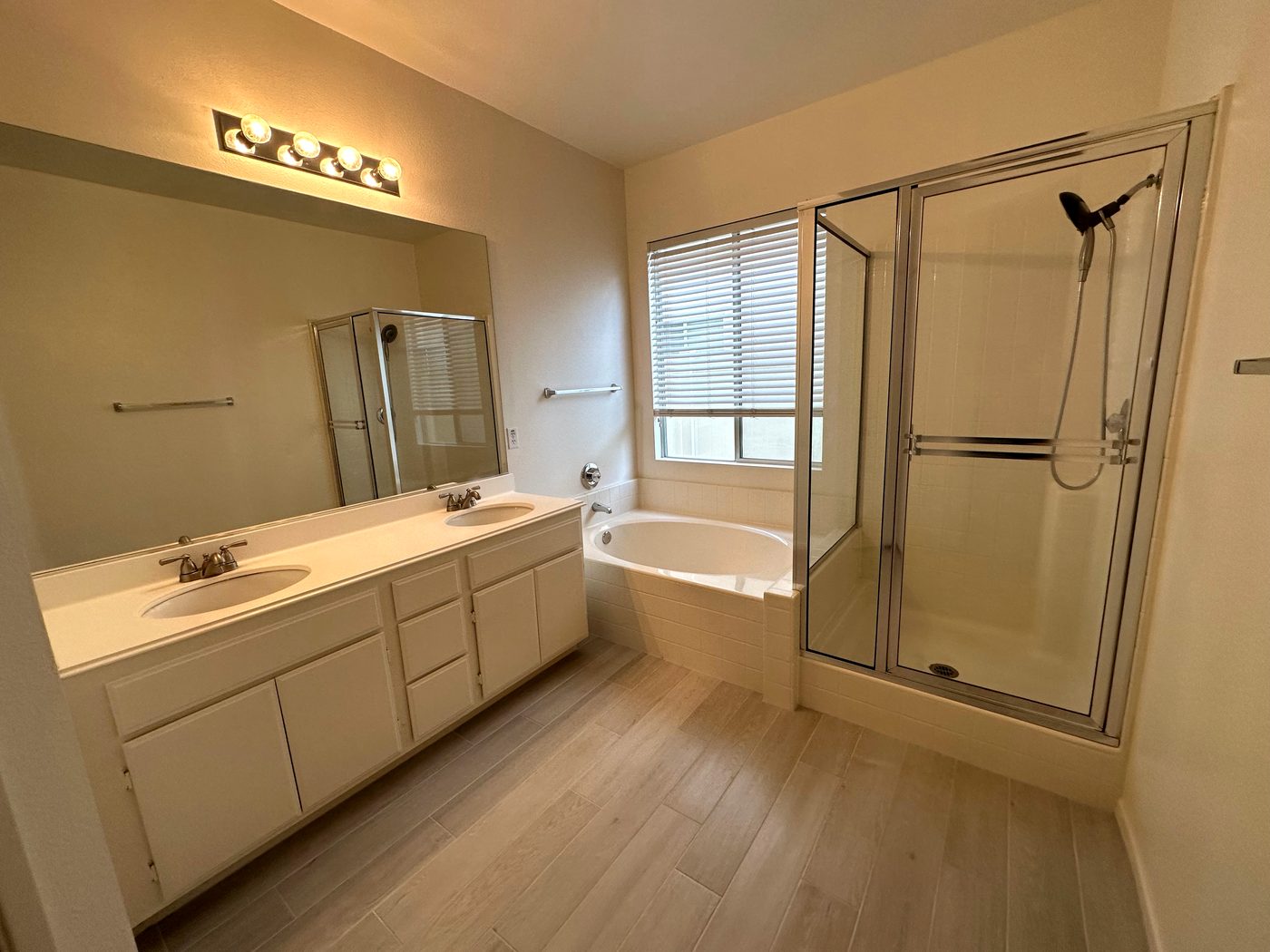 Bathroom with soaking tub and glass shower after cleaning