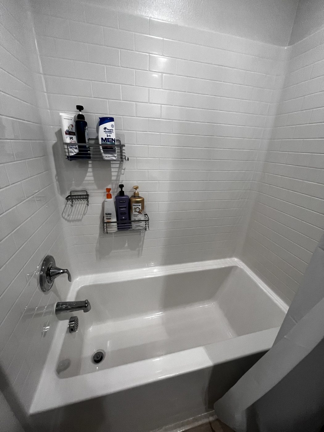 White tub and subway tile surround after a deep clean
